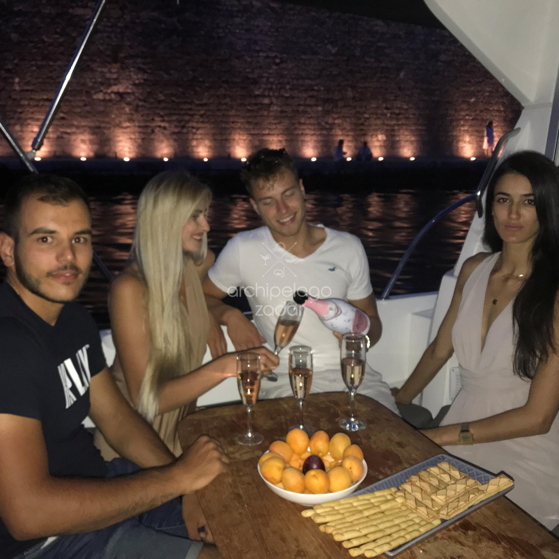 people drinking champagne on a boat in Zadar in foša