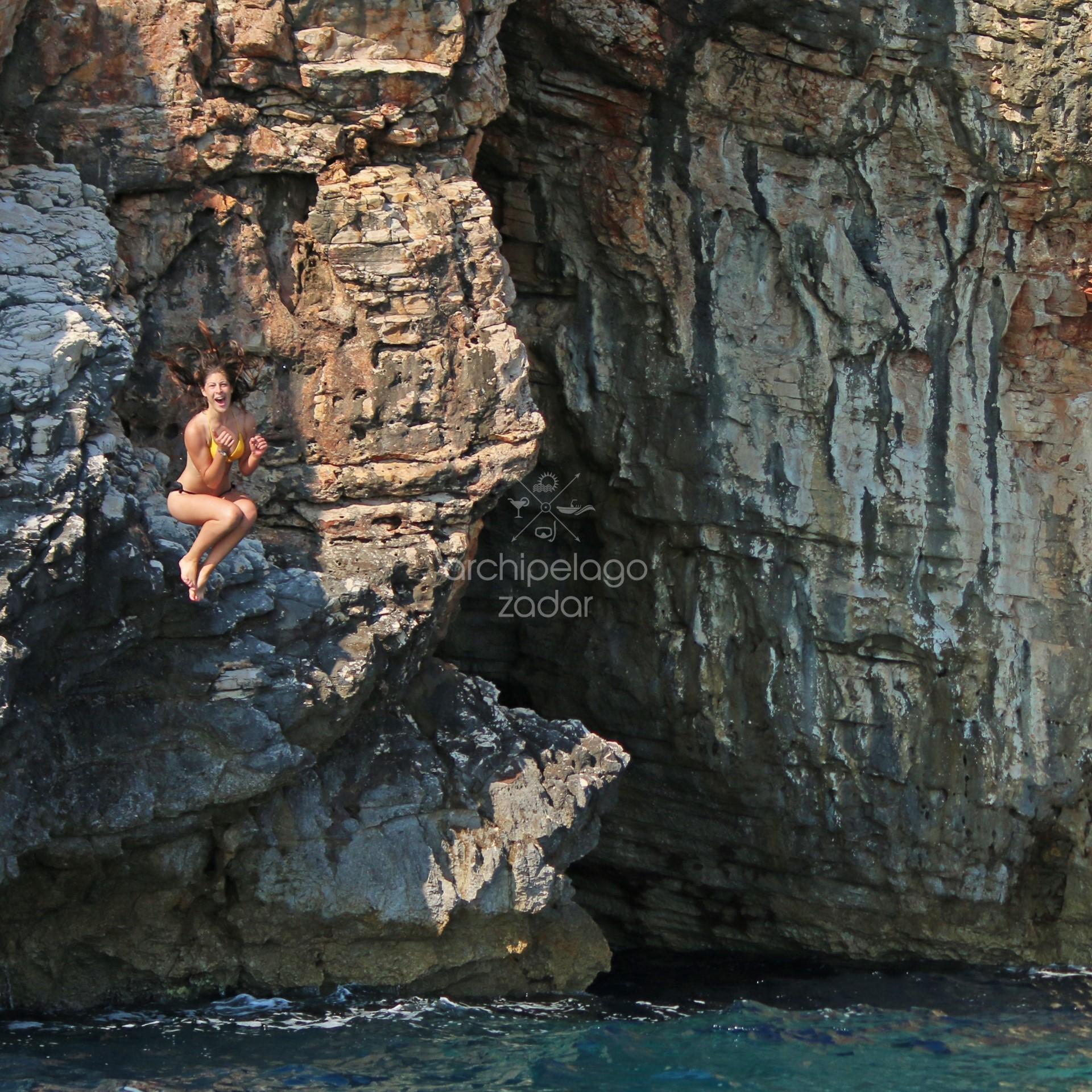 girl Cliff jumping on a boat tour from Zadar