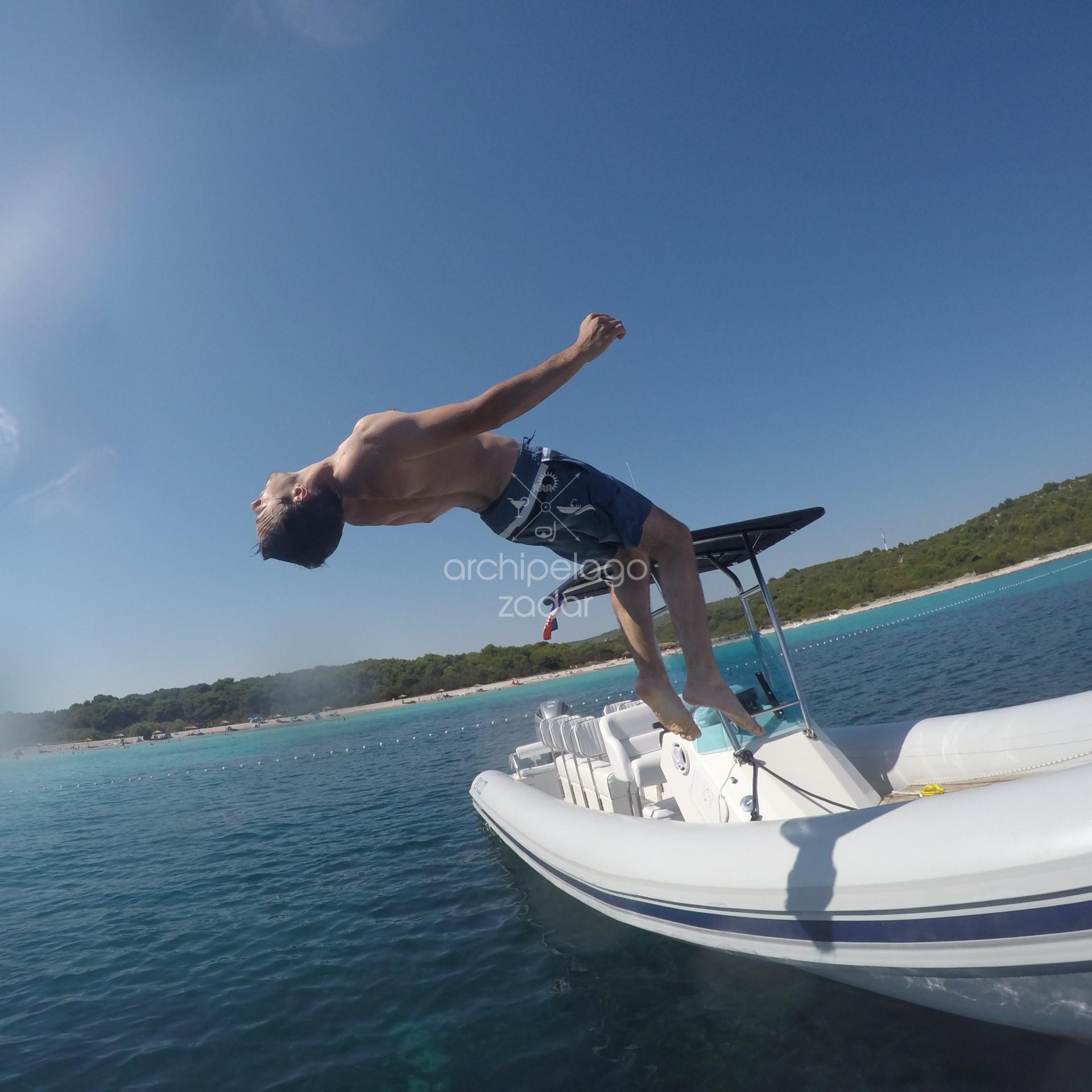 guy jumping from the boat 