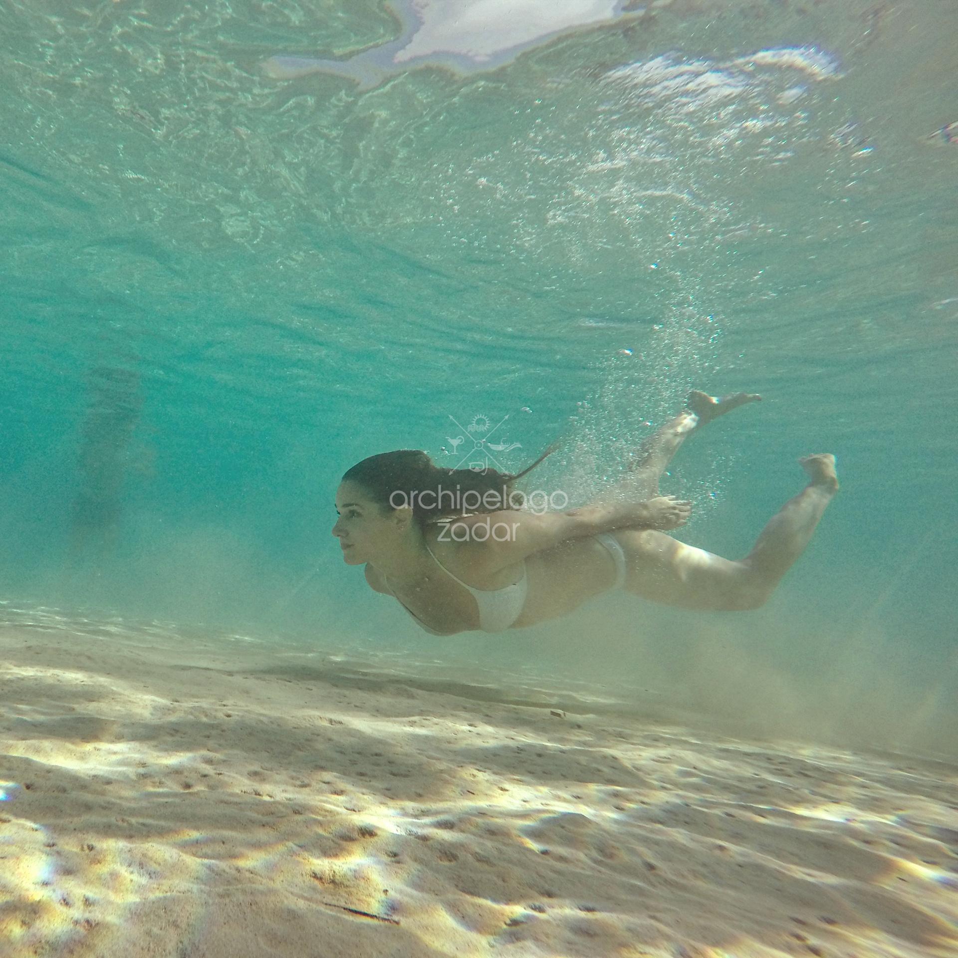 girl snorkelling in swimsuit on Kornati islands
