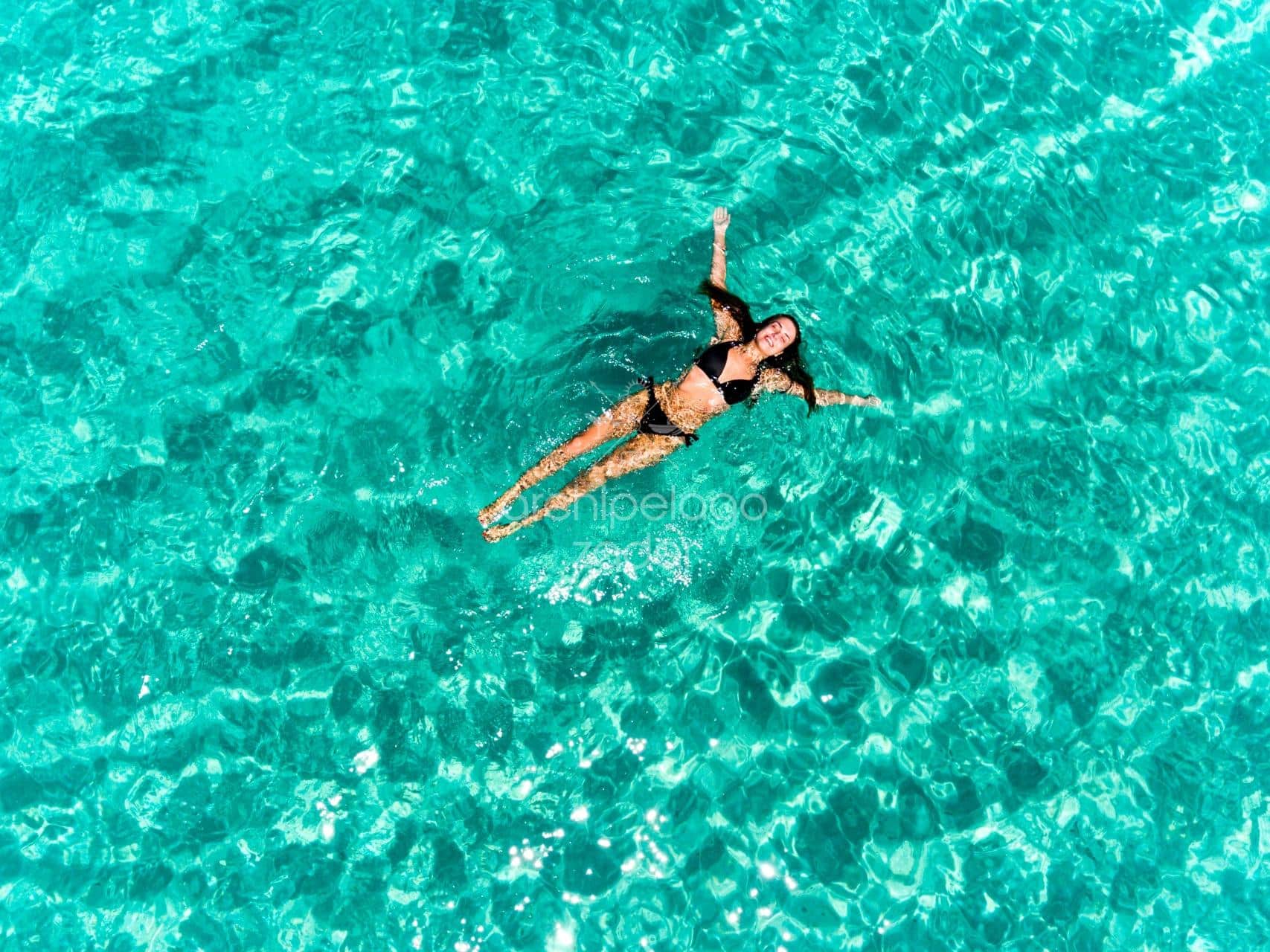floating girl in sea molat island bay girl swimming